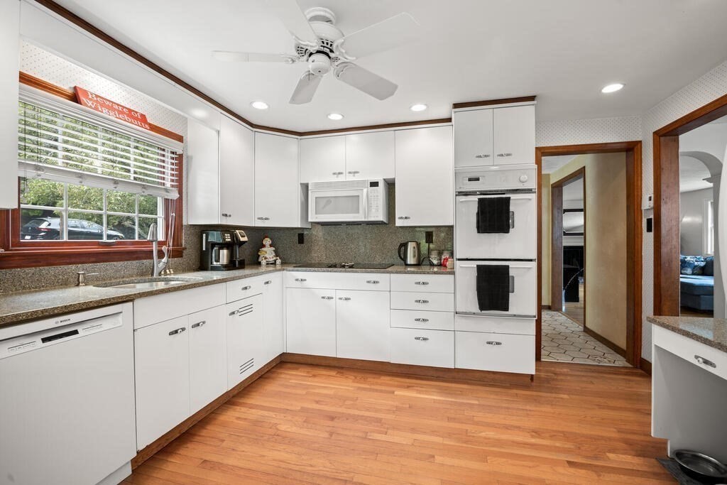 155 Main Street Winchester, MA 01890 - Photo 12 of 35 a kitchen with stainless steel appliances kitchen island granite countertop a stove a sink and a refrigerator