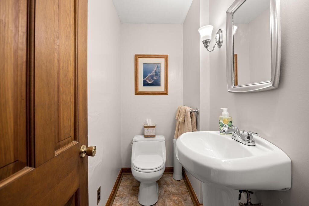 155 Main Street Winchester, MA 01890 - Photo 14 of 35 a bathroom with a sink a toilet and mirror