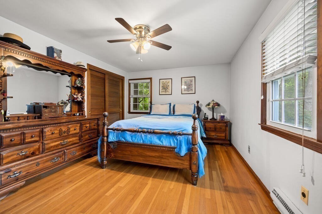 155 Main Street Winchester, MA 01890 - Photo 18 of 35 a bedroom with a bed and a chandelier