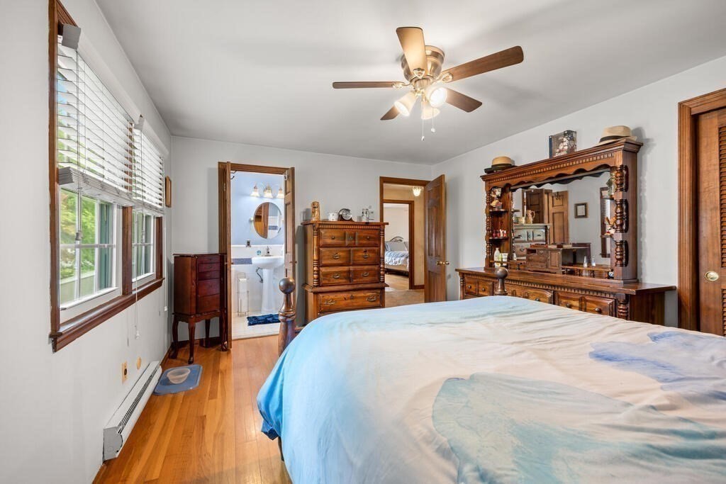155 Main Street Winchester, MA 01890 - Photo 19 of 35 a bedroom with a large bed a flat tv screen and a large window