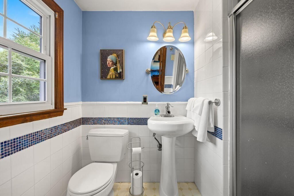 155 Main Street Winchester, MA 01890 - Photo 20 of 35 a bathroom with a toilet a sink and a mirror