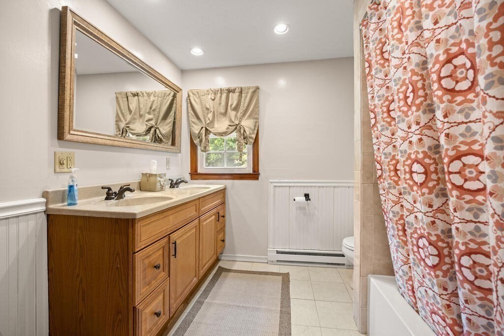 155 Main Street Winchester, MA 01890 - Photo 22 of 35 a bathroom with a granite countertop sink and a mirror