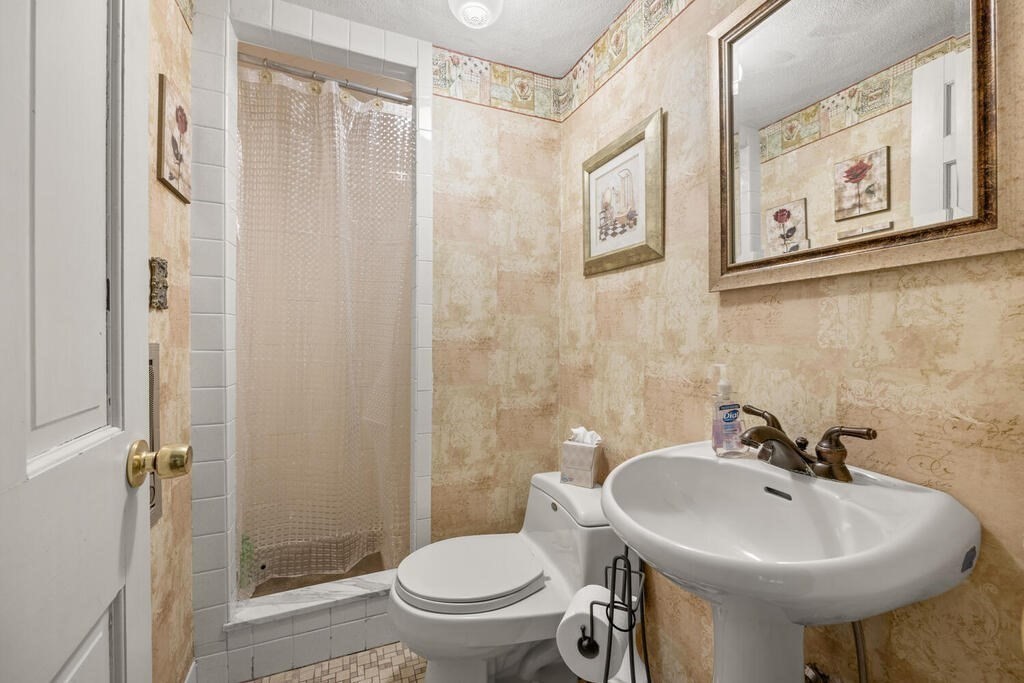 155 Main Street Winchester, MA 01890 - Photo 23 of 35 a bathroom with a sink a toilet and shower