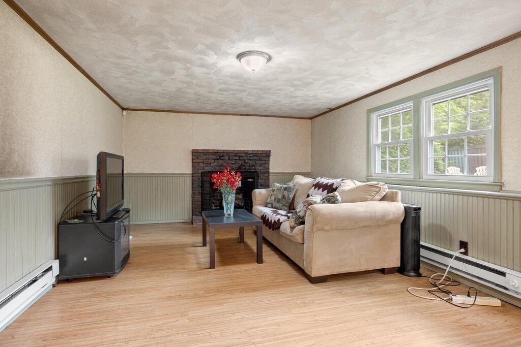 155 Main Street Winchester, MA 01890 - Photo 24 of 35 a living room with furniture gym equipment and a large window