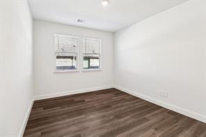 2448 Glacier Ridge Corinth, TX 76210 - Photo 11 of 27 a view of an empty room with wooden floor and a window
