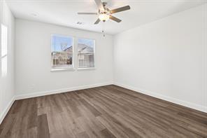 2448 Glacier Ridge Corinth, TX 76210 - Photo 12 of 27 wooden floor in an empty room with a window