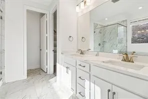 a spacious bathroom with a shower sink and mirror