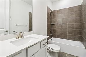 2448 Glacier Ridge Corinth, TX 76210 - Photo 22 of 27 a bathroom with a sink a toilet and shower
