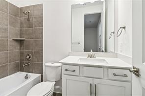 2448 Glacier Ridge Corinth, TX 76210 - Photo 23 of 27 a bathroom with a sink toilet vanity and shower