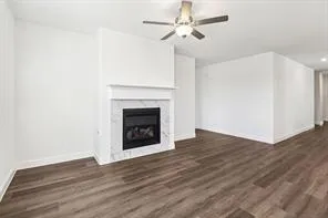 a view of empty room with wooden floor and fireplace