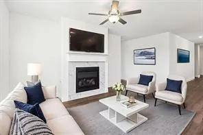 a living room with furniture a flat screen tv and a fireplace