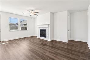 2448 Glacier Ridge Corinth, TX 76210 - Photo 7 of 27 a view of an empty room with wooden floor and a window