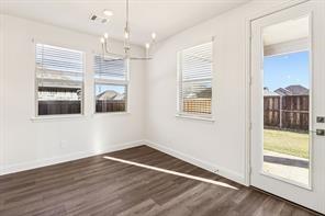 2448 Glacier Ridge Corinth, TX 76210 - Photo 8 of 27 a view of empty room with wooden floor and fan