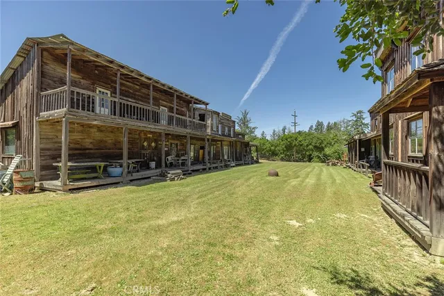 a view of a field with a tree in the background