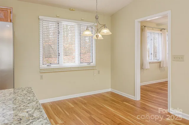 a view of a livingroom with wooden floor and a window