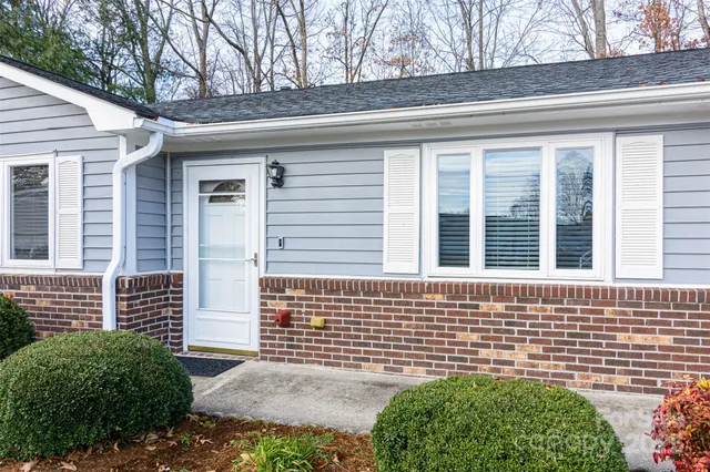a view of house with a backyard
