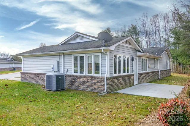 a front view of house with a garden