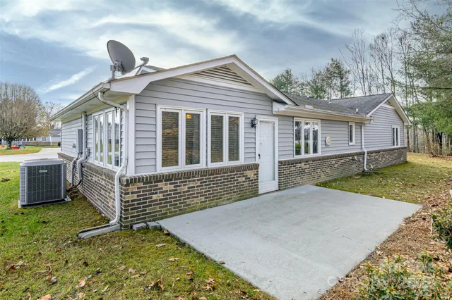 a front view of a house with a garden and yard