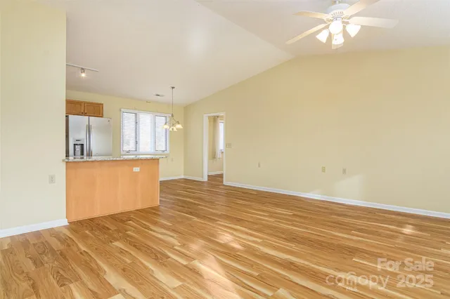 a view of a kitchen with kitchen island and wooden floor