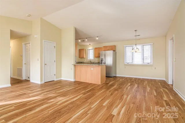 a view of a kitchen with wooden floor and a kitchen