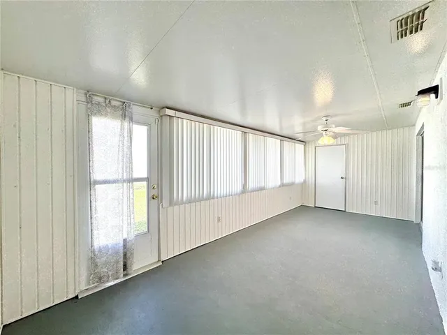 an empty room with a empty space and windows