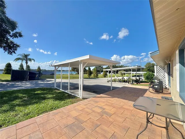 an aerial view of residential houses with outdoor space and ocean view