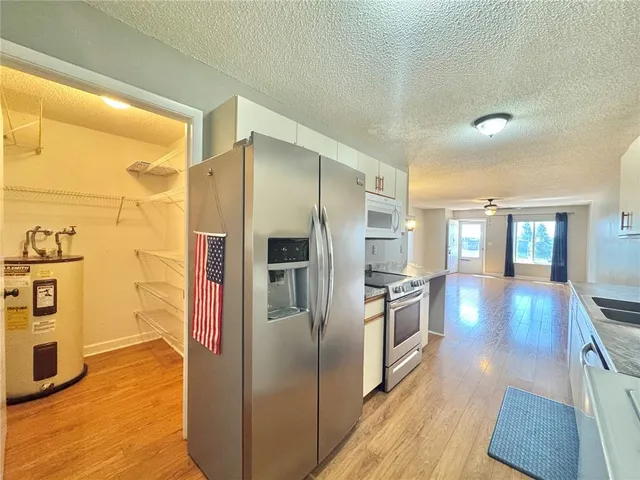 a kitchen with stainless steel appliances granite countertop a refrigerator and a stove