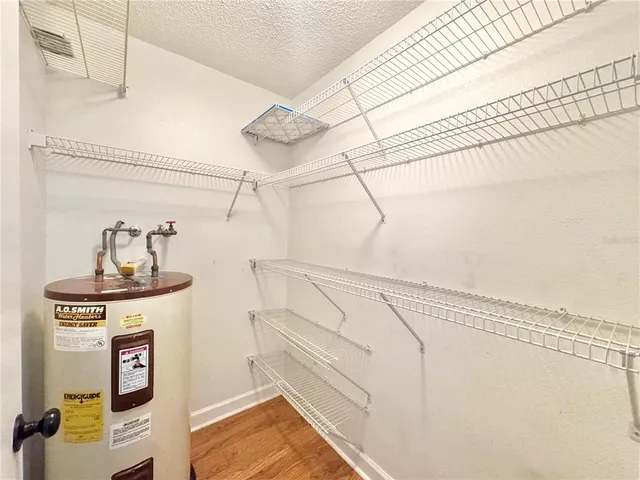 a view of a storage and utility room with racks on the wall