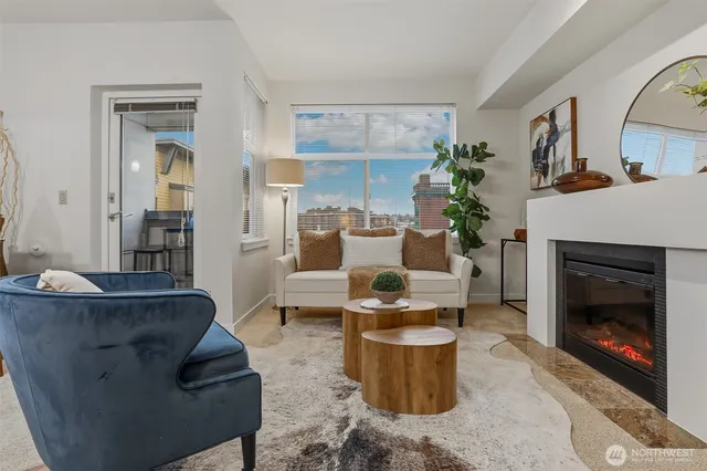 a living room with furniture a fireplace and a large mirror