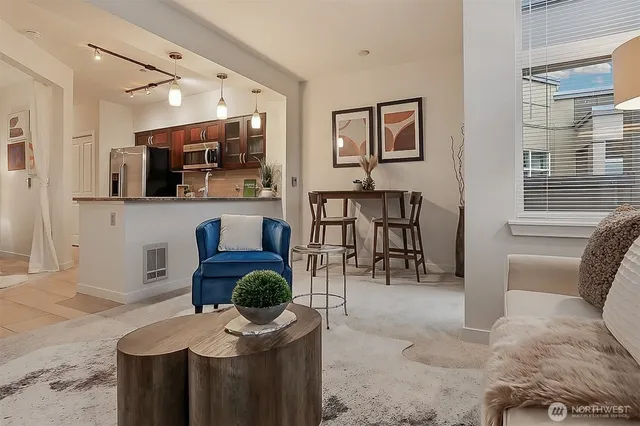 a living room with furniture a flat screen tv and white walls