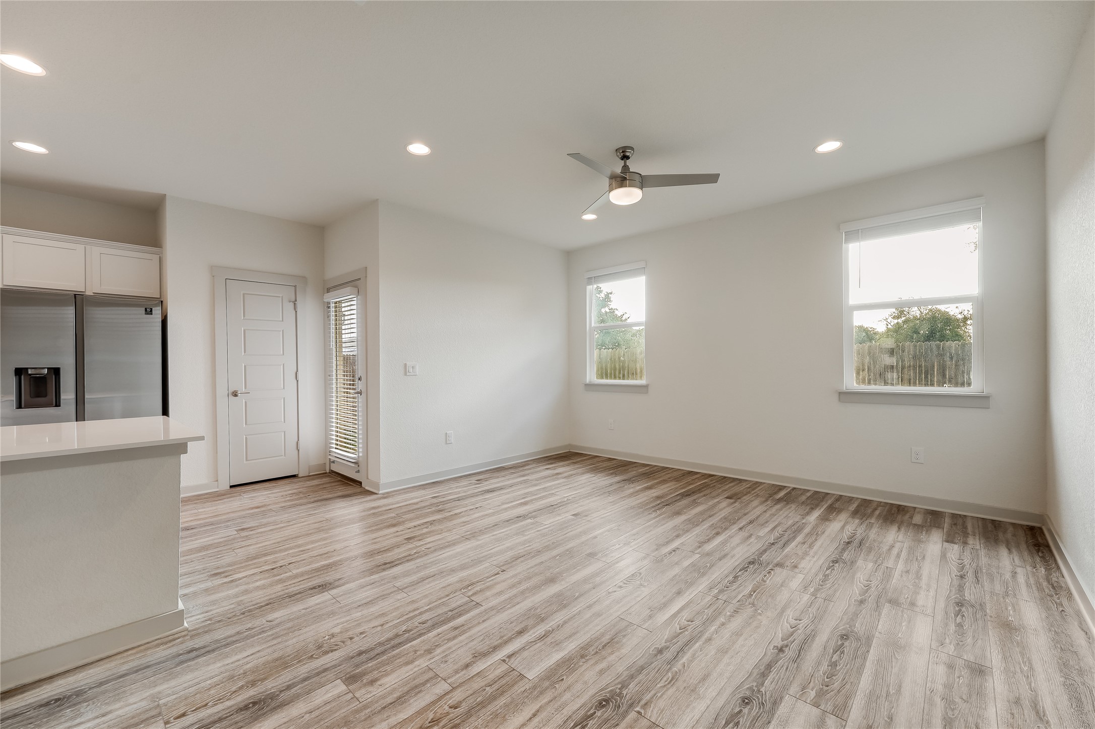 153 Filifera Court Leander, TX 78641 - Photo 12 of 33 a view of an empty room with a window and wooden floor
