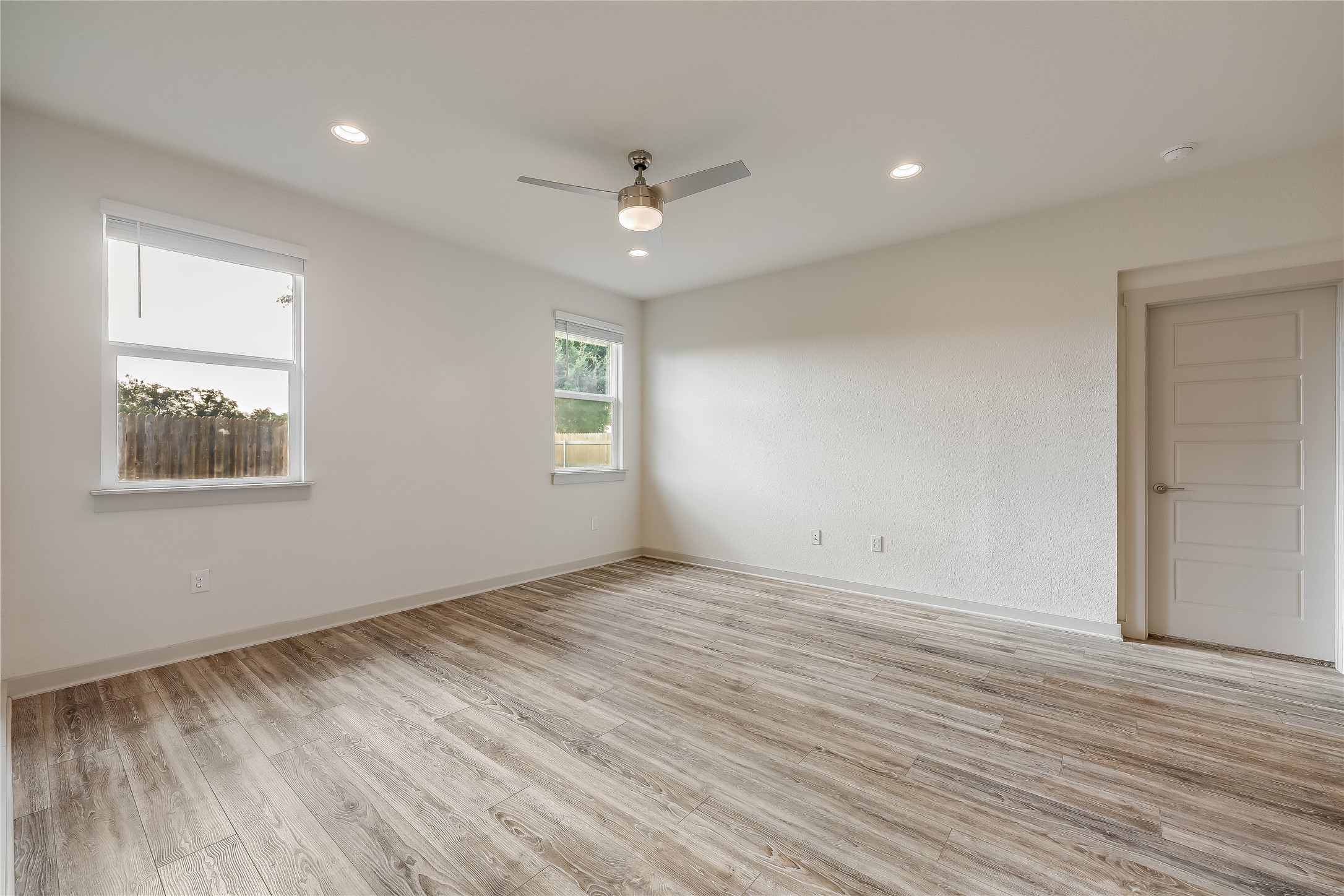 153 Filifera Court Leander, TX 78641 - Photo 19 of 33 a view of an empty room with wooden floor and a window