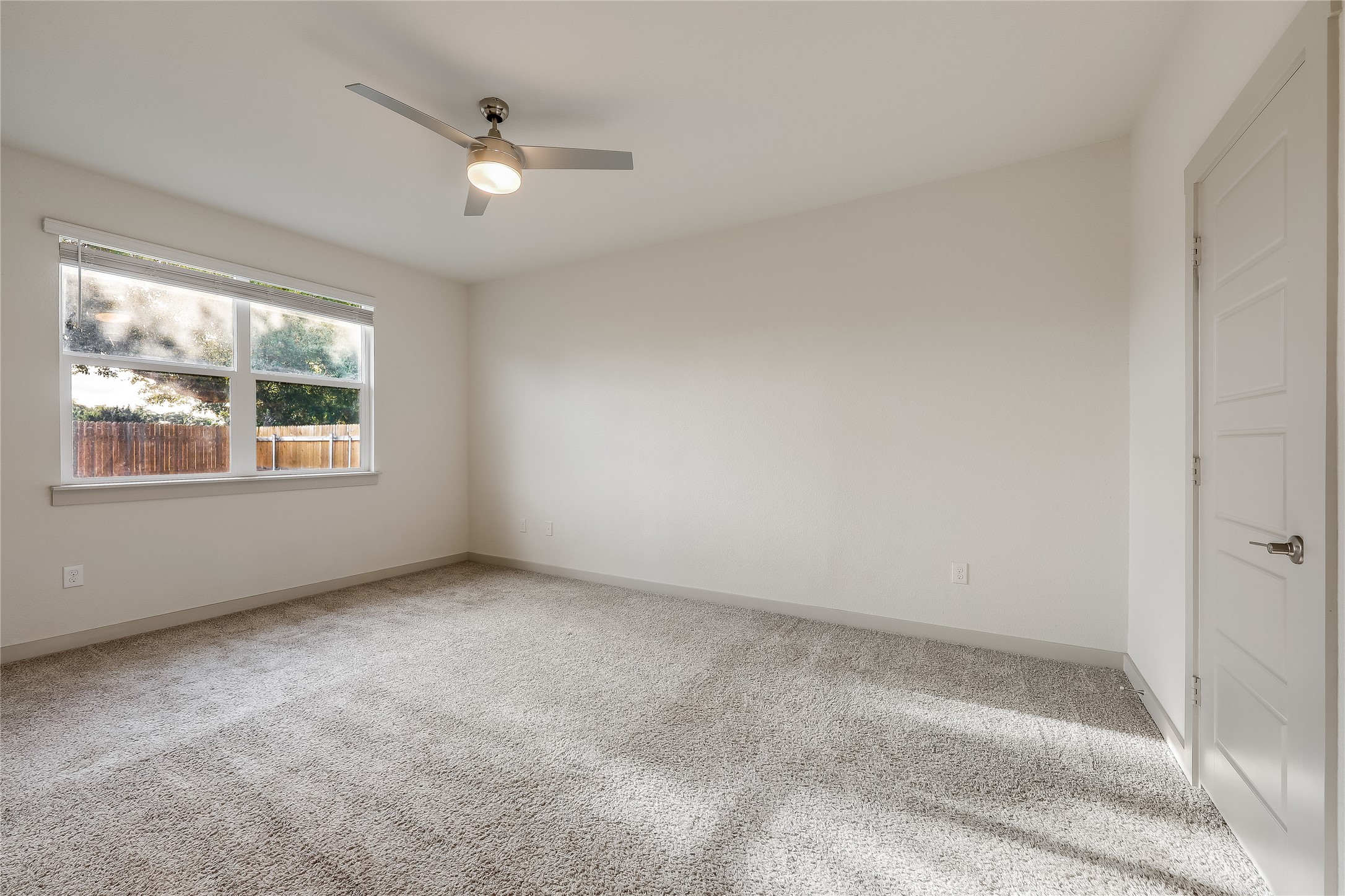 153 Filifera Court Leander, TX 78641 - Photo 20 of 33 an empty room with windows and ceiling fan