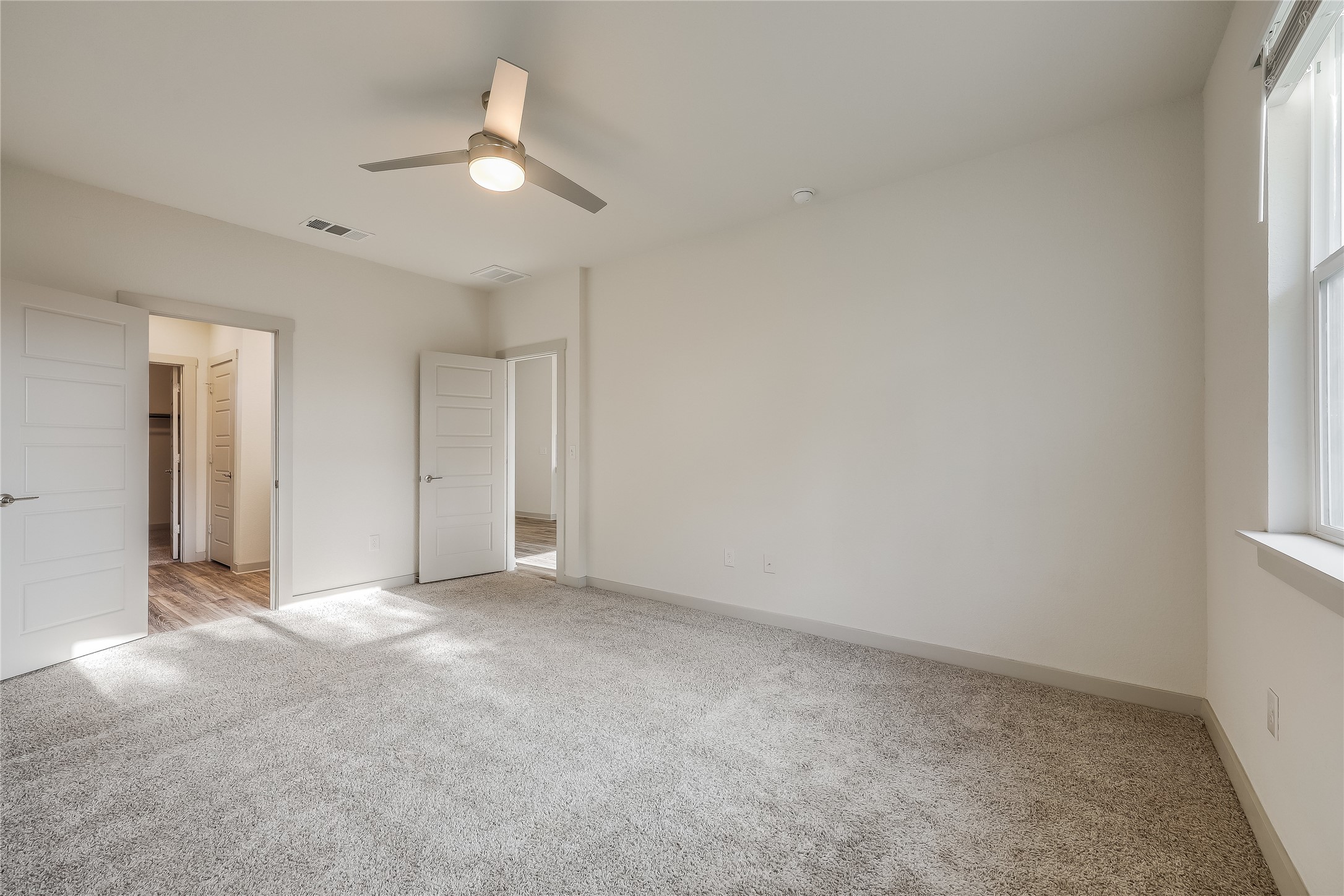 153 Filifera Court Leander, TX 78641 - Photo 21 of 33 an empty room with a ceiling fan and window