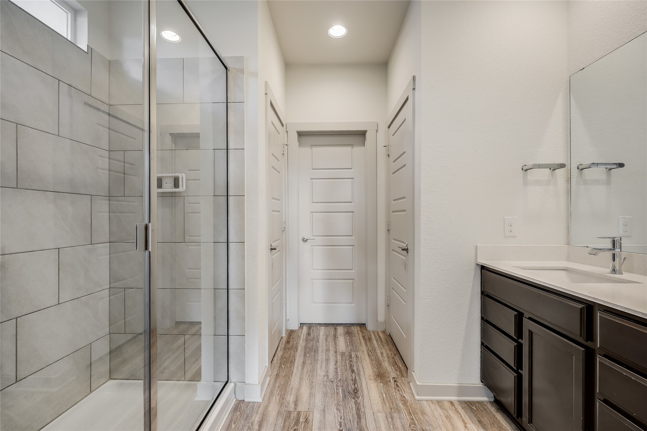 153 Filifera Court Leander, TX 78641 - Photo 23 of 33 a bathroom with a sink and shower