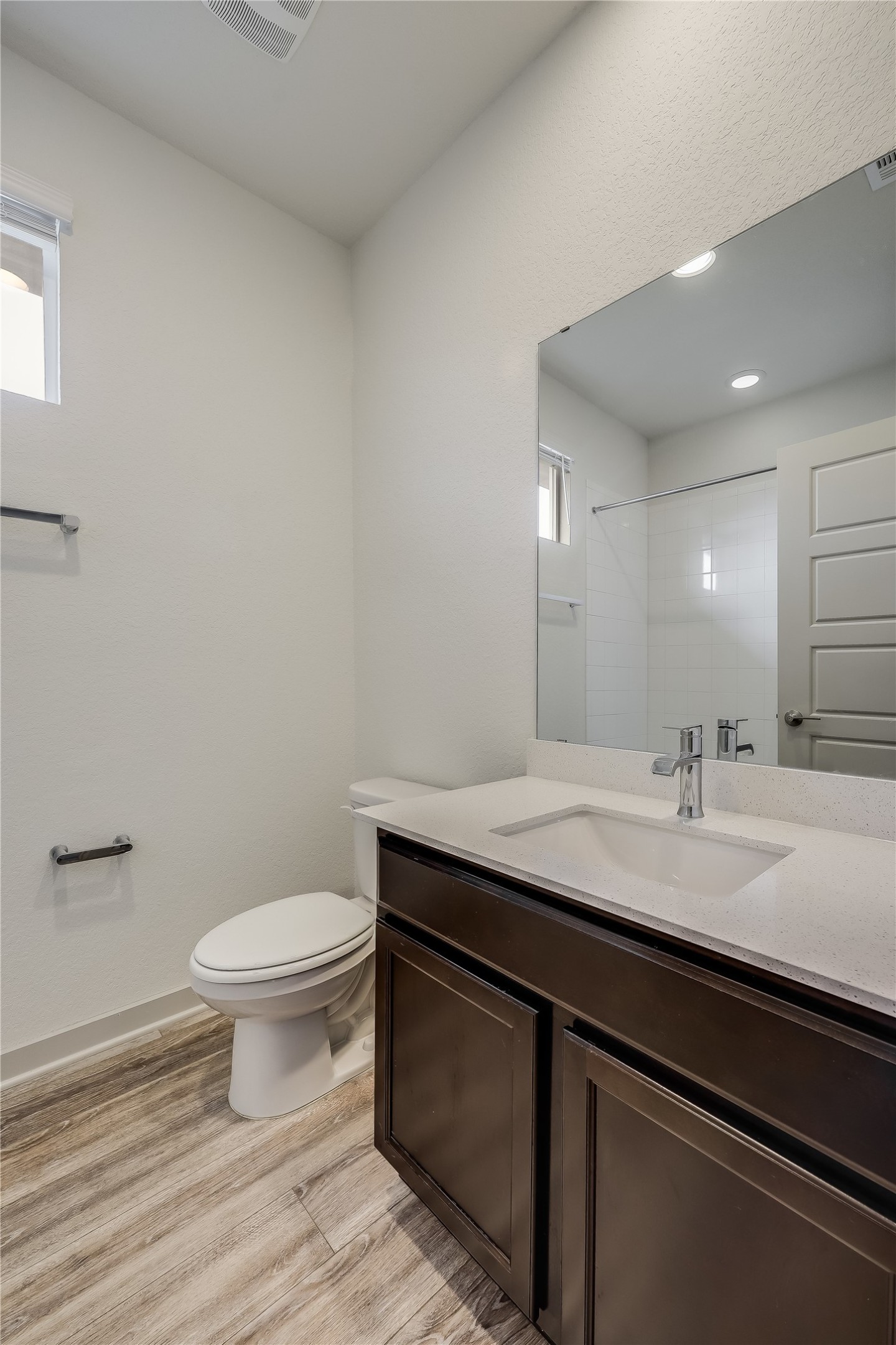 153 Filifera Court Leander, TX 78641 - Photo 25 of 33 a bathroom with a granite countertop sink a toilet and a mirror
