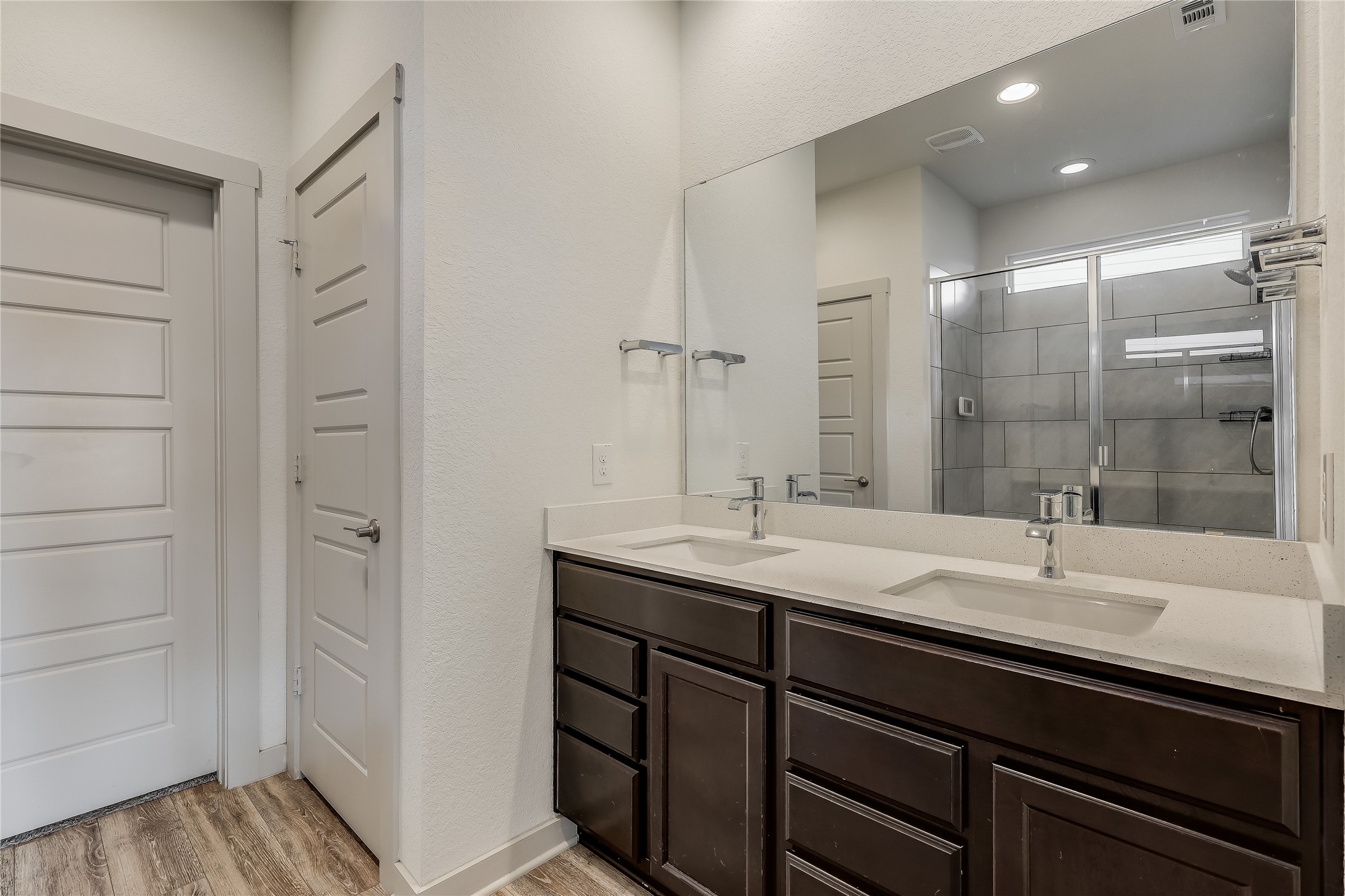 153 Filifera Court Leander, TX 78641 - Photo 27 of 33 a bathroom with a granite countertop sink and a mirror