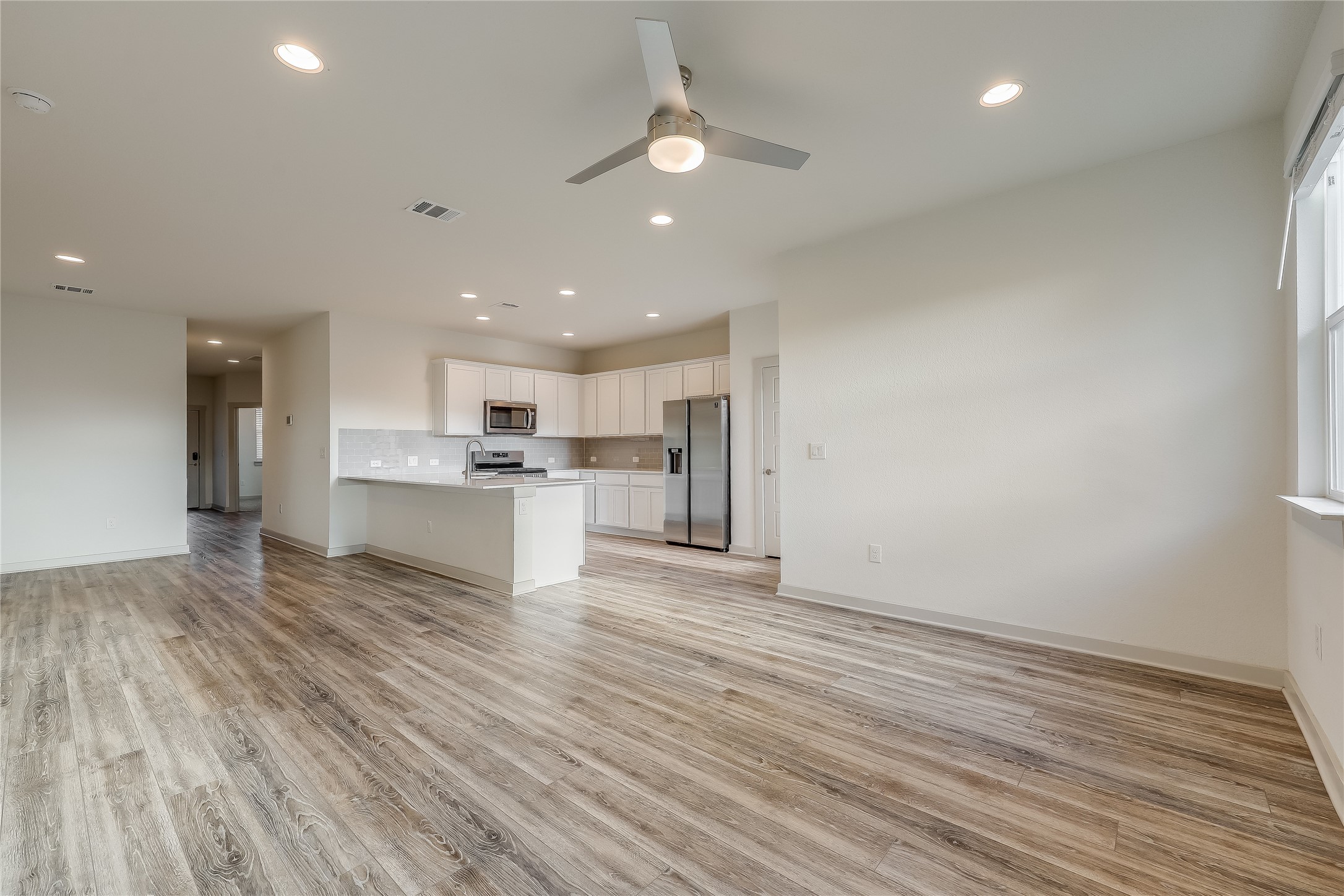 153 Filifera Court Leander, TX 78641 - Photo 6 of 33 a view of kitchen view wooden floor and window