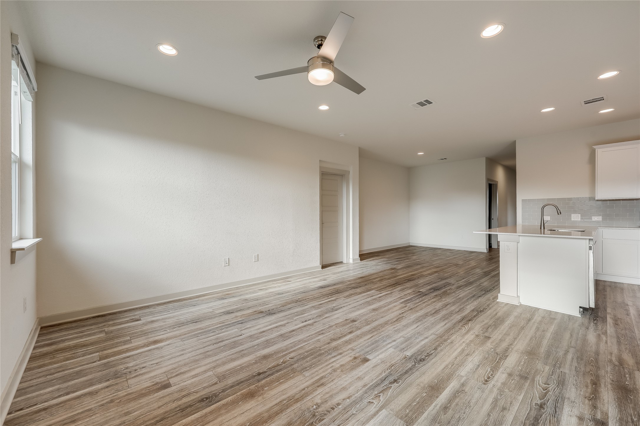 153 Filifera Court Leander, TX 78641 - Photo 8 of 33 wooden floor in an empty room with a window