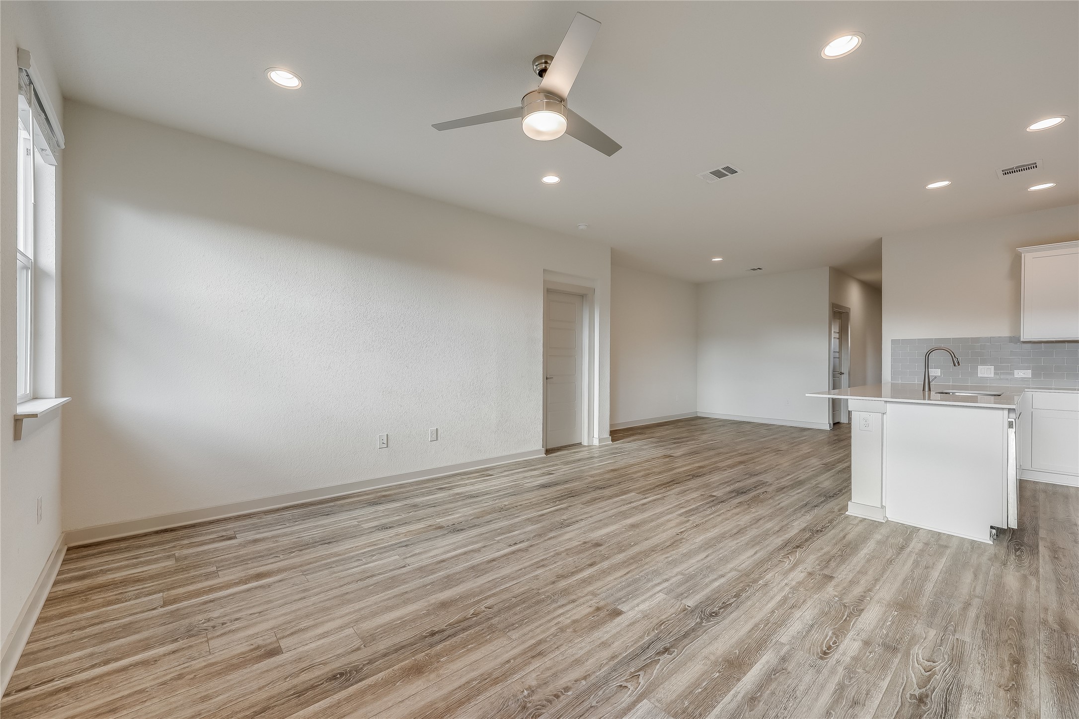 153 Filifera Court Leander, TX 78641 - Photo 10 of 33 wooden floor in an empty room with a window