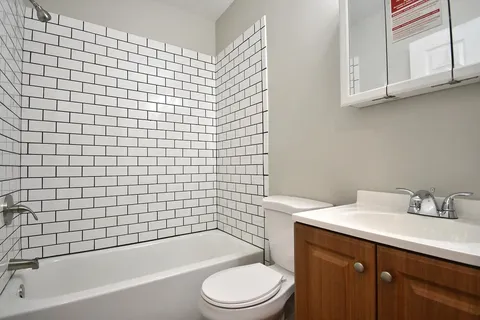 a bathroom with a sink a toilet and bathtub