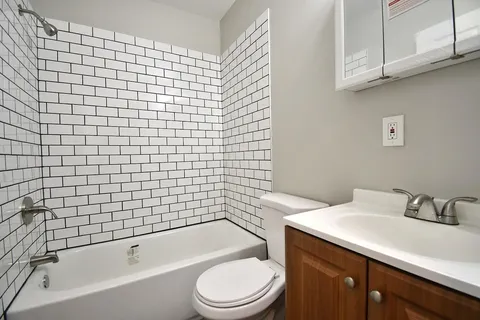 a bathroom with a sink a toilet and bathtub