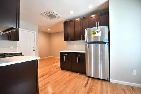 a view of kitchen with cabinets and wooden floor