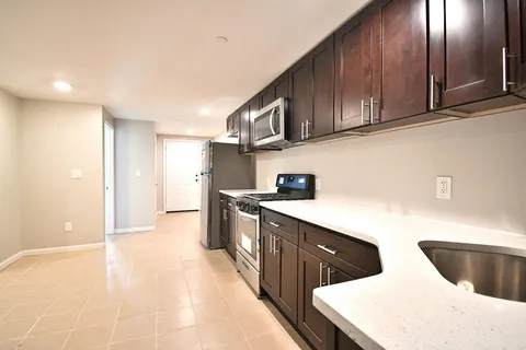 a kitchen with stainless steel appliances granite countertop a sink and cabinets