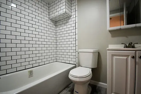 a bathroom with a sink a toilet and bathtub