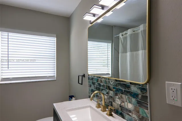 a bathroom with a sink and a mirror