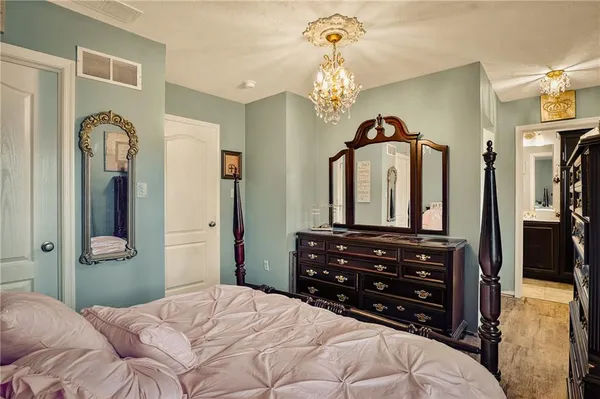 a bedroom with a bed and a mirror