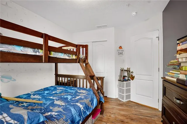 a bedroom with a bed and a tv on the dresser
