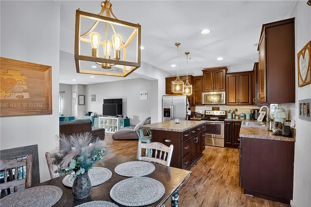 a living room with furniture kitchen view and a large window