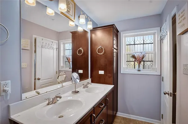 a bathroom with a sink a mirror and a shower